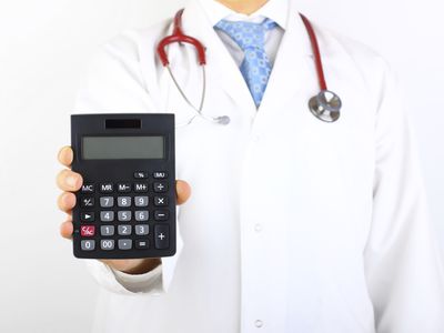 Doctor holding a calculator.