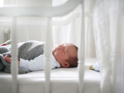 A new born sleeping in his cradle